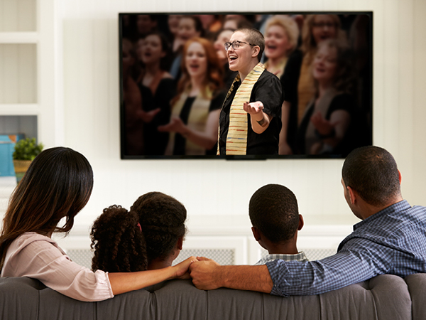 African American family watching tv