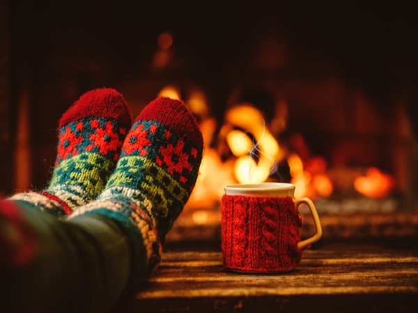 Feet in front of a fire with mug