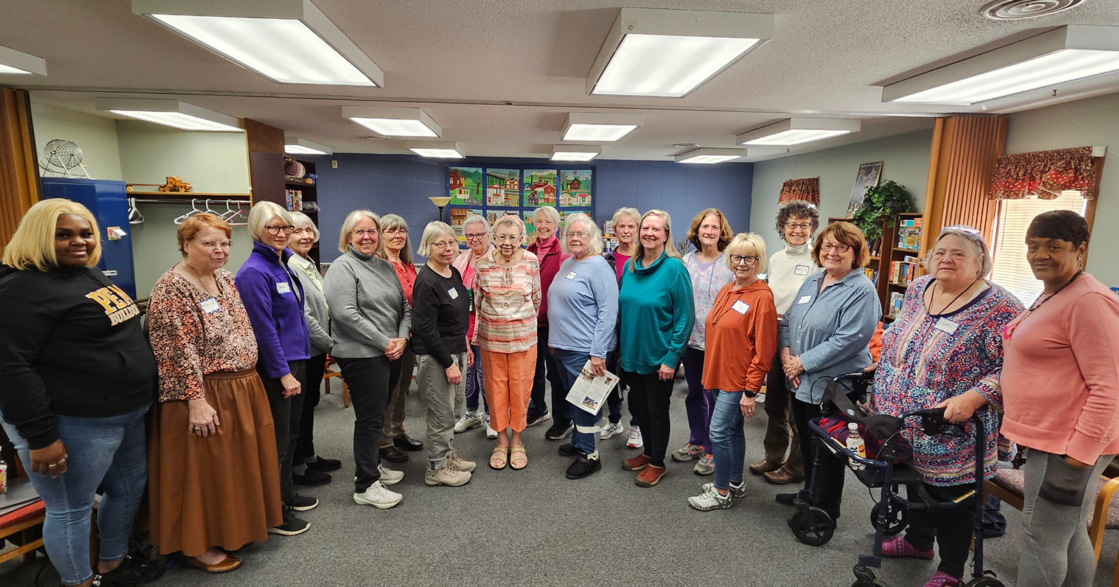 Members of the Keystone Community Singers standing in a curved row looking at the camera.