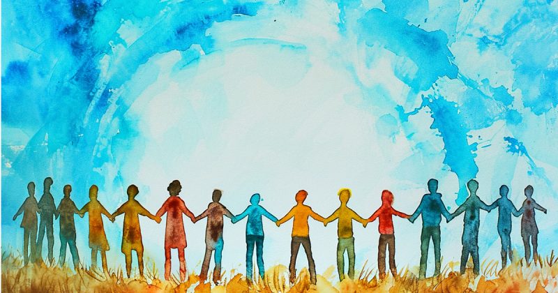 A watercolor illustration of a group of people standing in brown and orange grasses holding hands and looking at a blue sky. Photo Credit: Adobe Stock Image