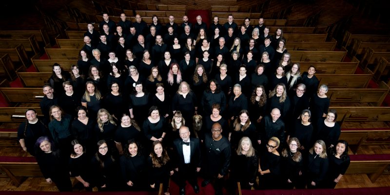 VocalEssence Chorus members wearing black pose for a photo. Photo Credit: Bruce Silcox