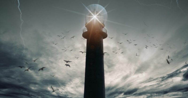 Image of a lighthouse in the midst of a storm with lightning, dark clouds, and birds flying.