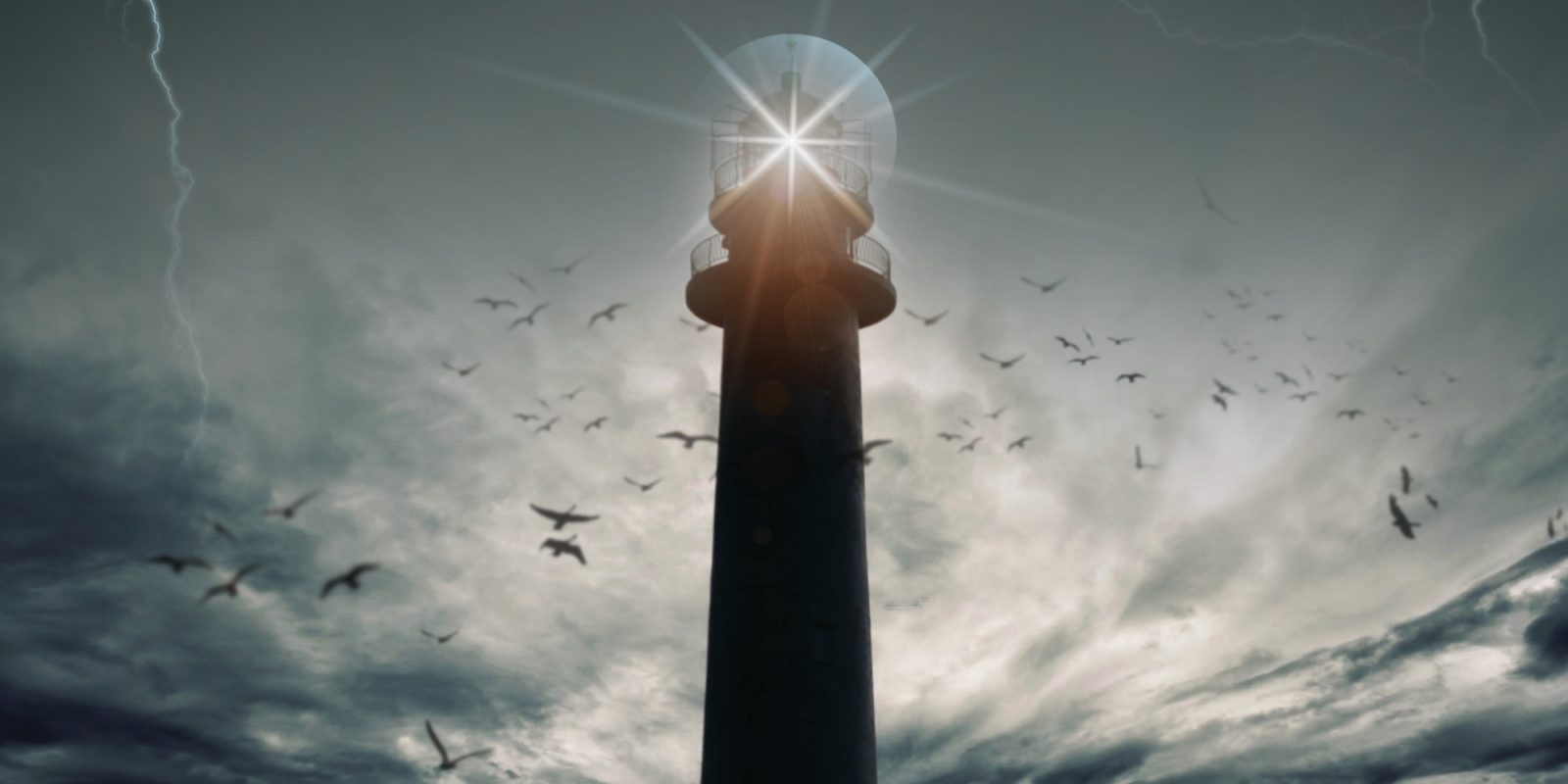 Image of a lighthouse in the midst of a storm with lightning, dark clouds, and birds flying.