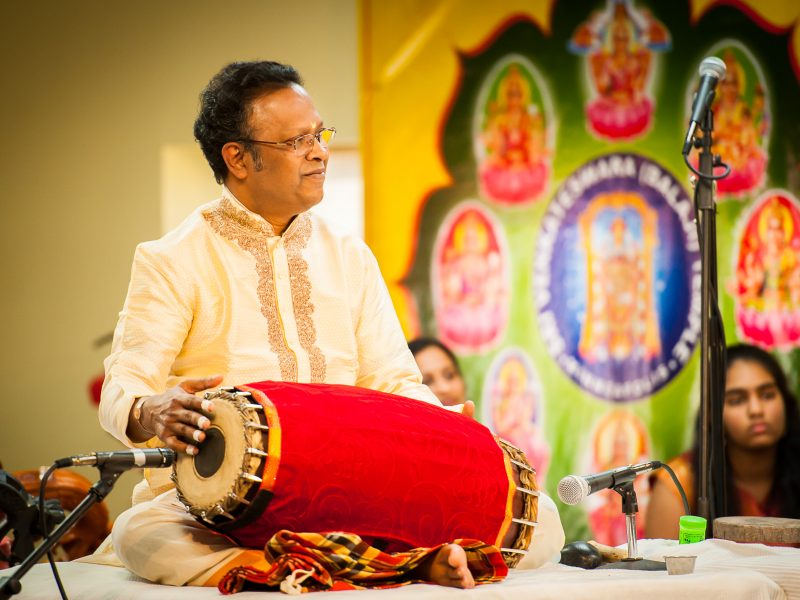 Thanjavur K. Murugaboopathi sits playing the mridangam, a South Indian hand drum. Photo Credit: ReyMash Photography